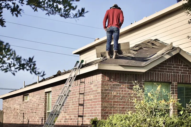 Professional roofer working on a residential roof in Matheson